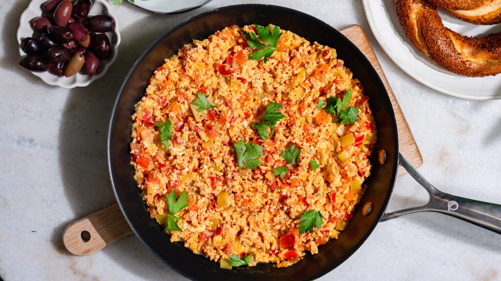 Menemen - Turkish scrambled eggs served in a pan.
Served with bread and olives.